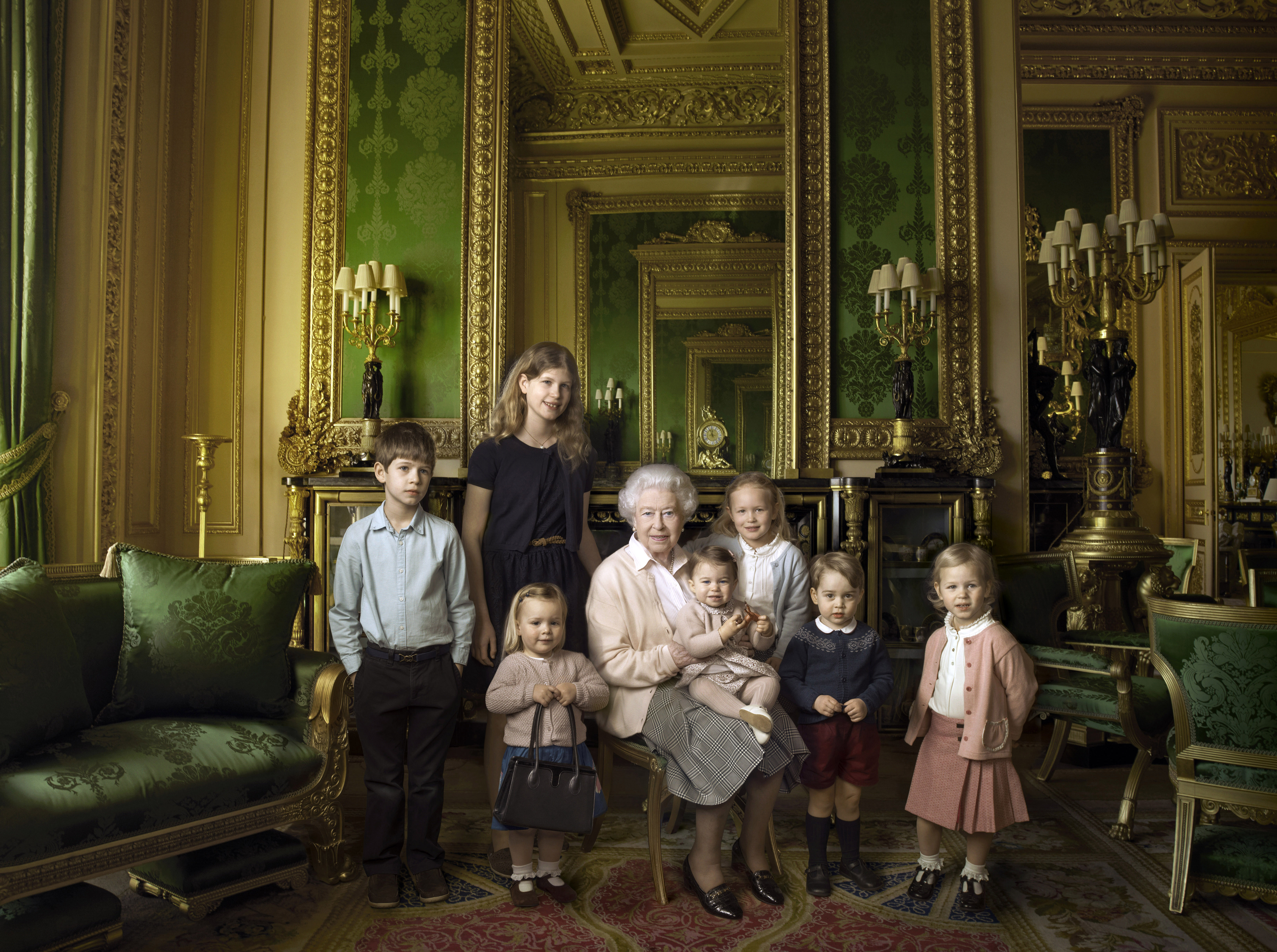 Queen Elizabeth posing with her great-grandchildren
