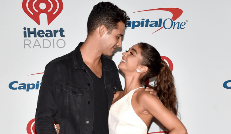 Wells Adams and Sarah Hyland being lovey at iHeart Radio carpet.