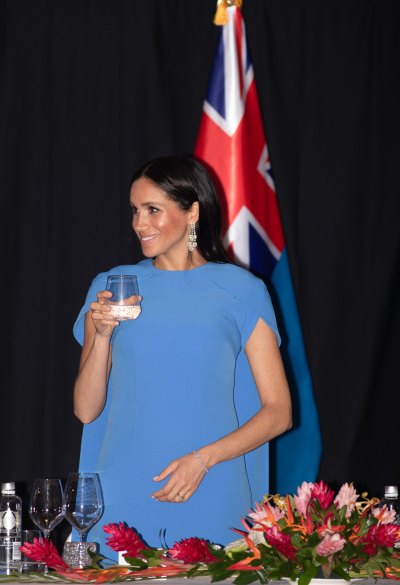 Meghan Markle holding a glass of water