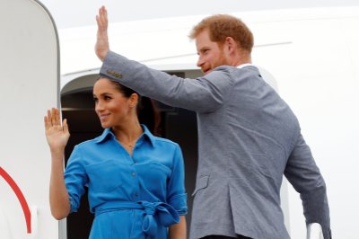 prince Harry and Meghan Markle waving