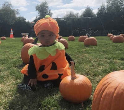 True Thompson wearing a pumpkin Halloween Costume
