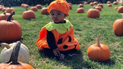True Thompson wearing a pumpkin Halloween costume