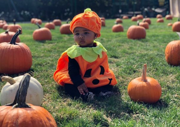 True Thompson wearing a pumpkin Halloween costume