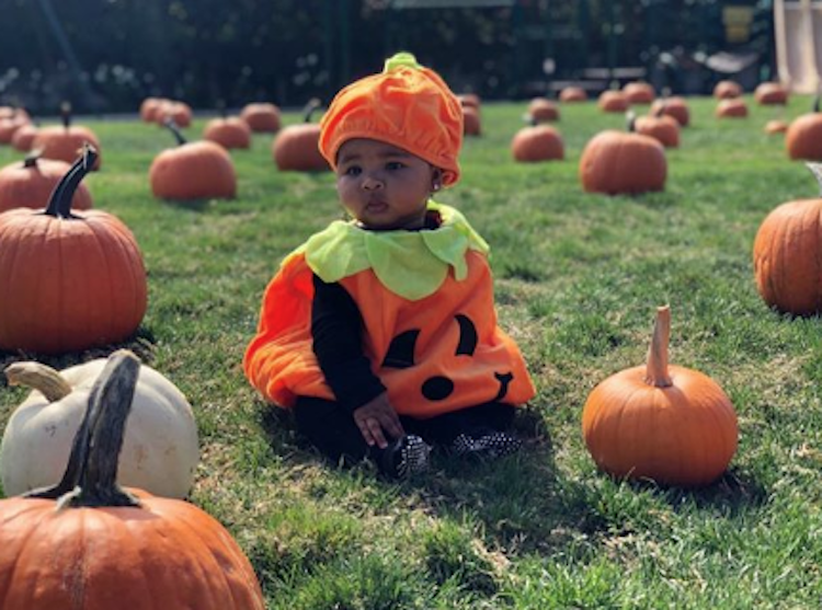 True Thompson wearing a pumpkin Halloween costume
