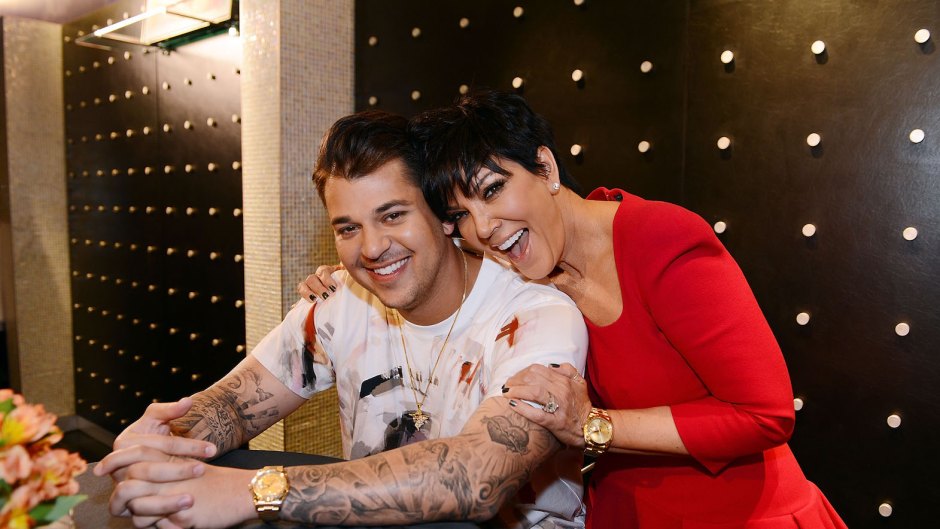 Rob Kardashian with his mom Kris Jenner, she is wearing a red shirt