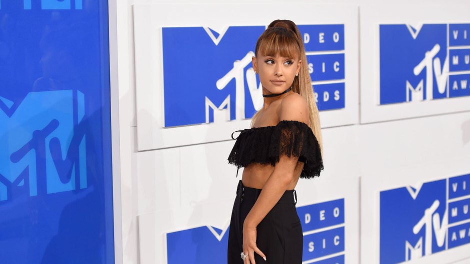 Ariana Grande wearing an off the shoulder black top