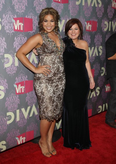 Jordin Sparks, wearing a gray dress with Kelly Clarkson, wearing a black dress at an event