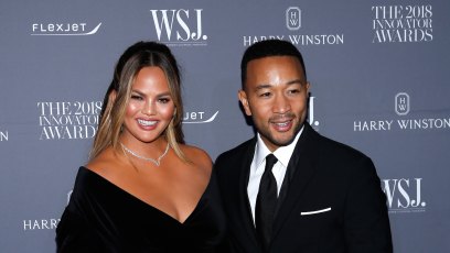 Chrissy Teigen and John Legend wearing all black at an event
