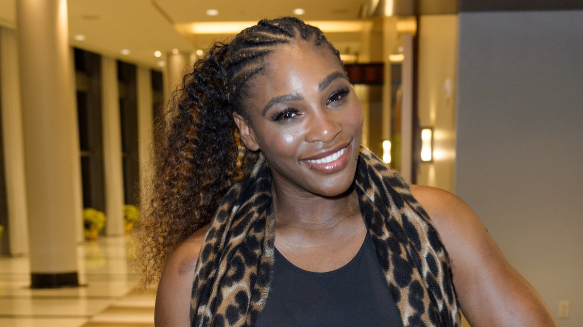 Serena williams exercises while holding Alexis Olympia