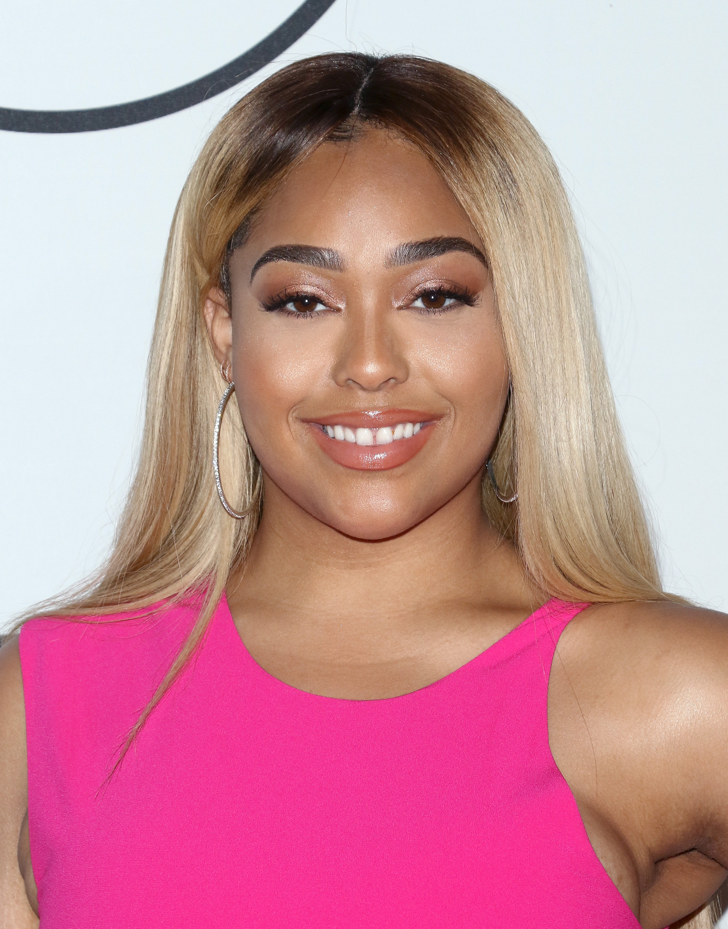Jordyn Woods pink dress blonde hair