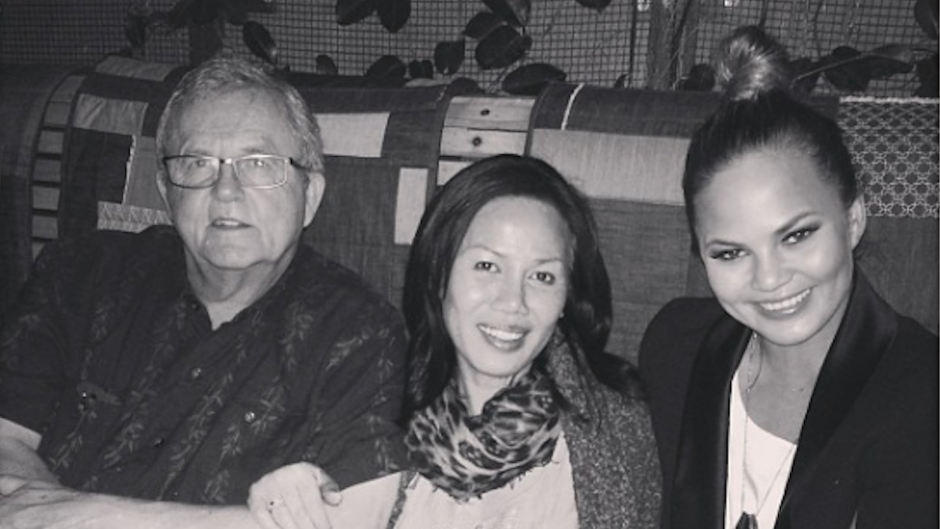 Chrissy Teigen with her mom and dad at a restaurant