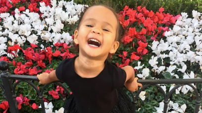 Chrissy Teigen's Daughter, Luna, Posing, Flowers, Black Dress, Smiling