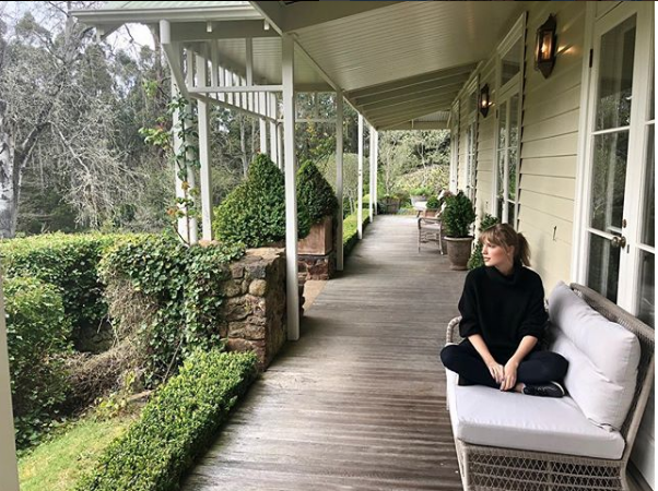 Taylor swift sitting on a porch