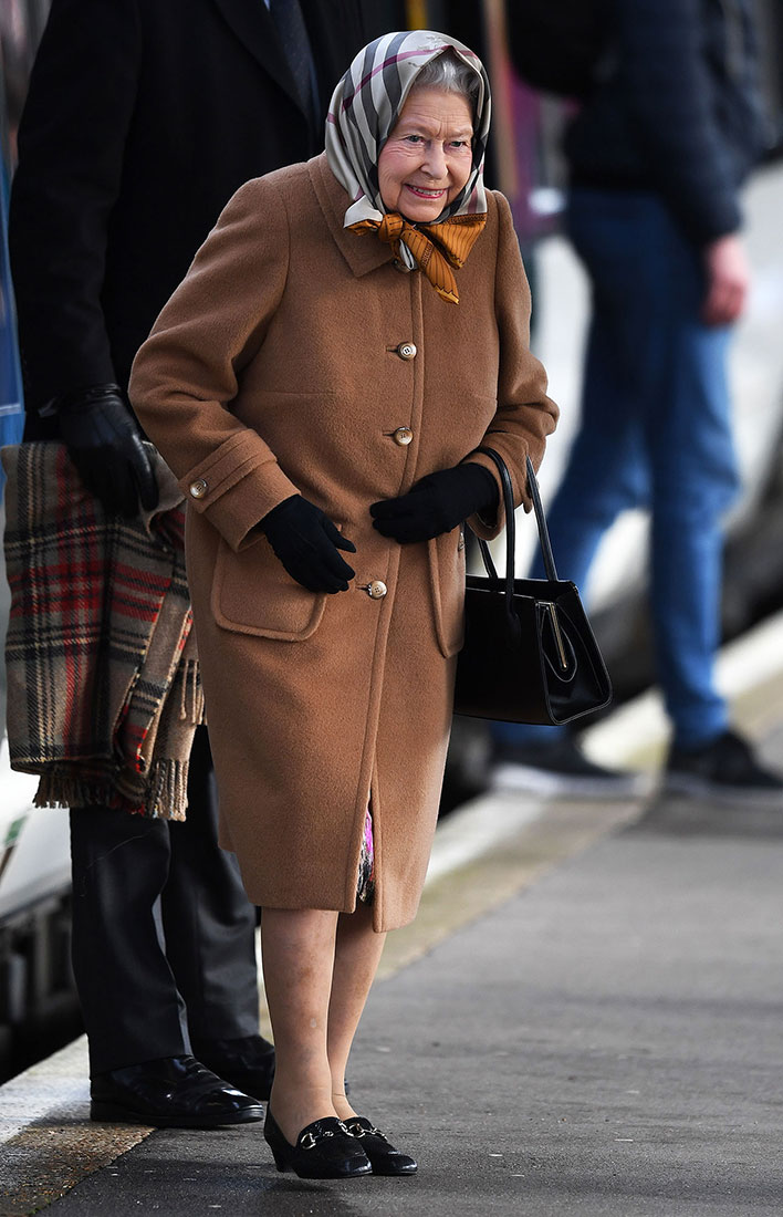 The Queen Wraps Up To Keep Warm While Riding Public Train Ahead Of The Holidays
