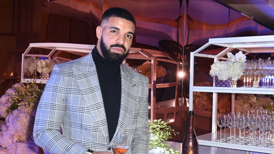 Drake wearing a gray suit at New Year's Eve party