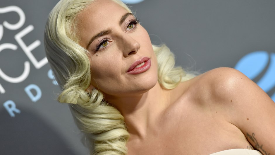 Upclose shot of Lady Gaga with curled blonde hair and a nude pink dress