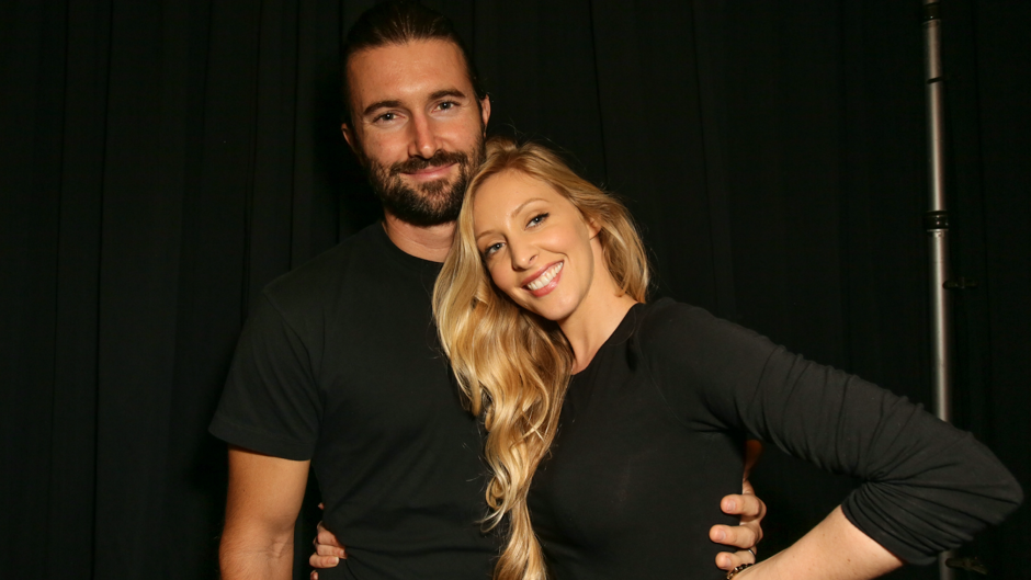 Brandon and Leah Jenner posing and smiling wearing all black outfits