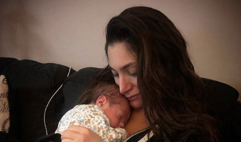 Deena Cortese holding her newborn baby