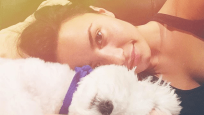 Demi Lovato laying down with her late dog Buddy