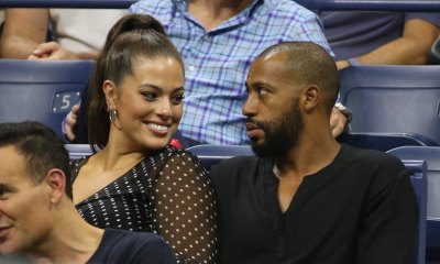 Ashley Graham sitting with husband Justin Ervin at the 2018 US open