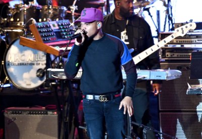 Chance the Rapper singing in a purple hat