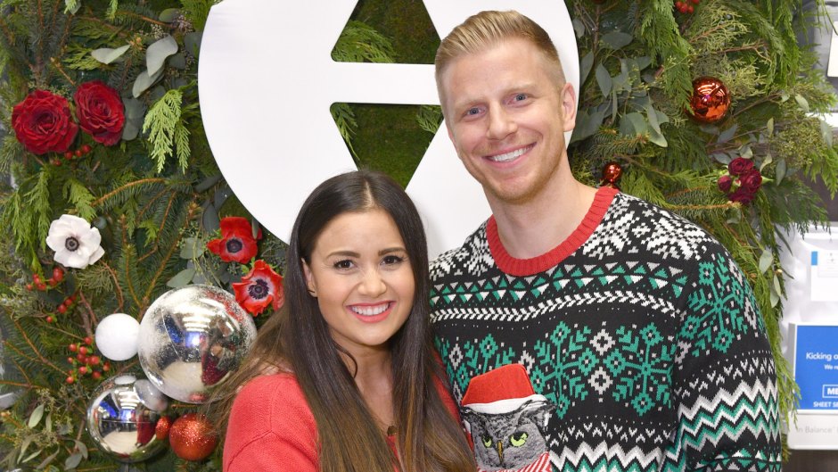 Sean Lowe wearing a Christmas sweater with wife Catherine Giudici