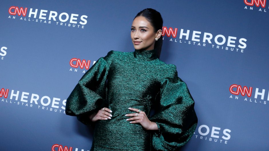 Shay Mitchell wearing a green dress at an event