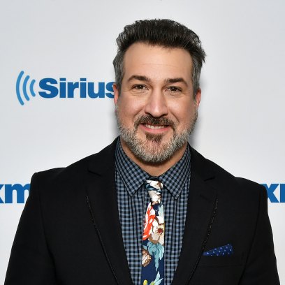 Joey Fatone wearing a suit at Sirius XM