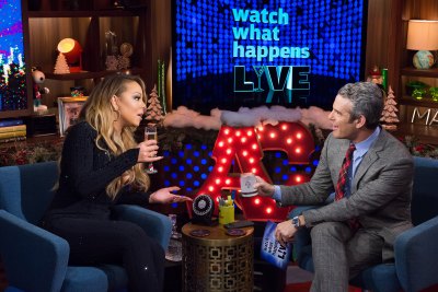 Mariah Carey drinking champagne with Andy Cohen