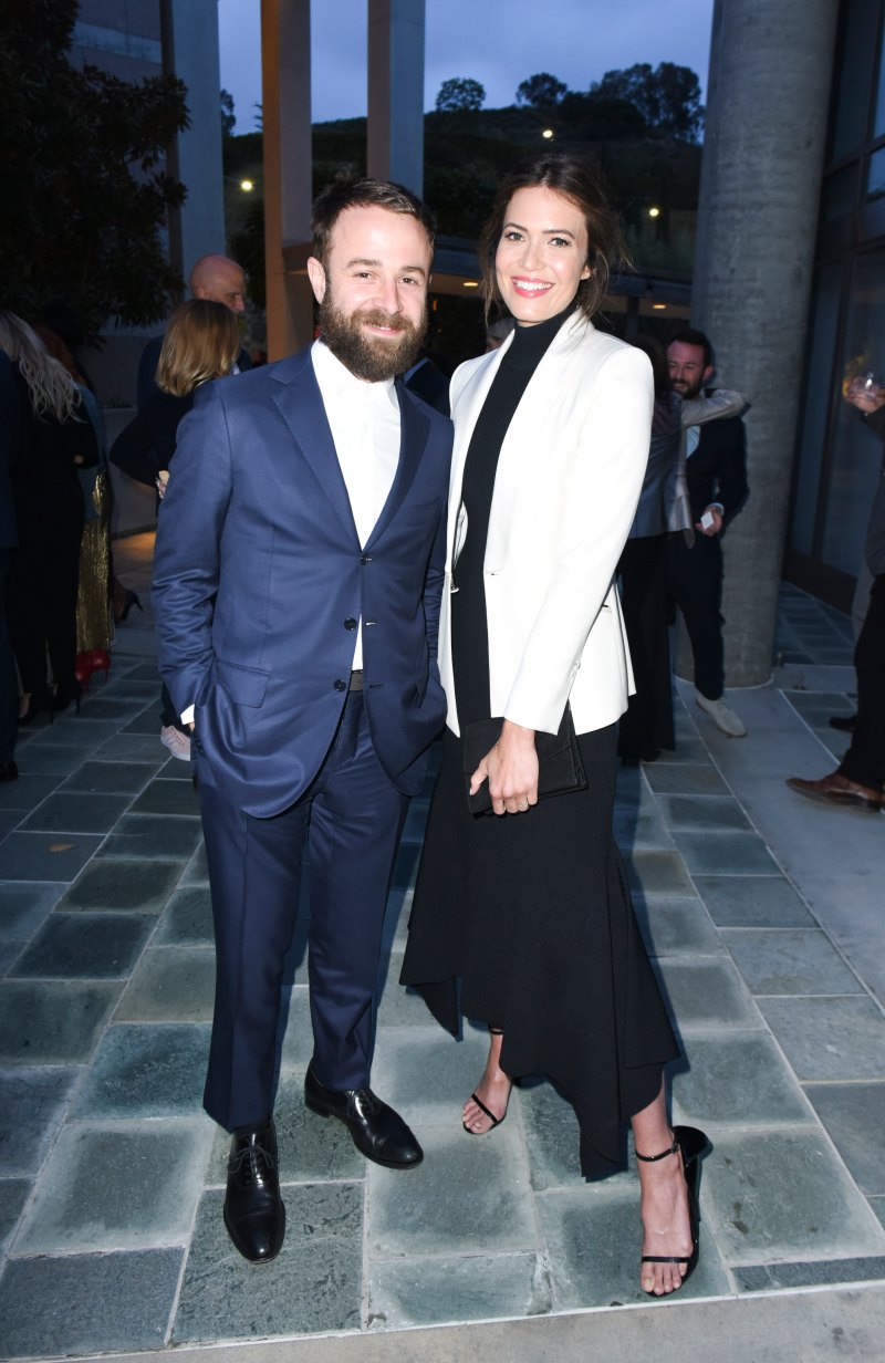 Mandy Moore wearing a white jacket with Taylor Goldsmith