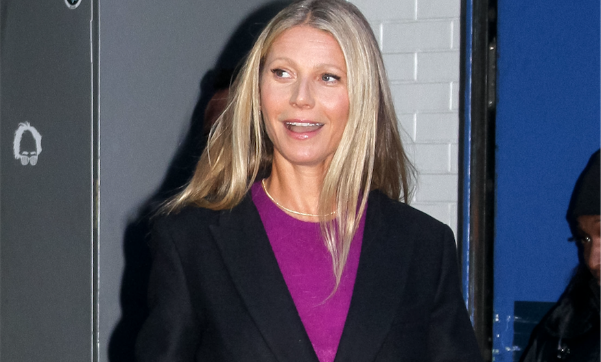 Gwyneth Paltrow walking in NYC wearing a purple sweater and black blazer