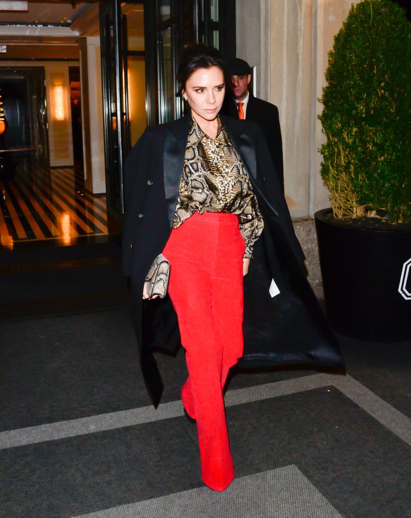 Victoria Beckham walking in NYC wearing red pants and cheetah print top