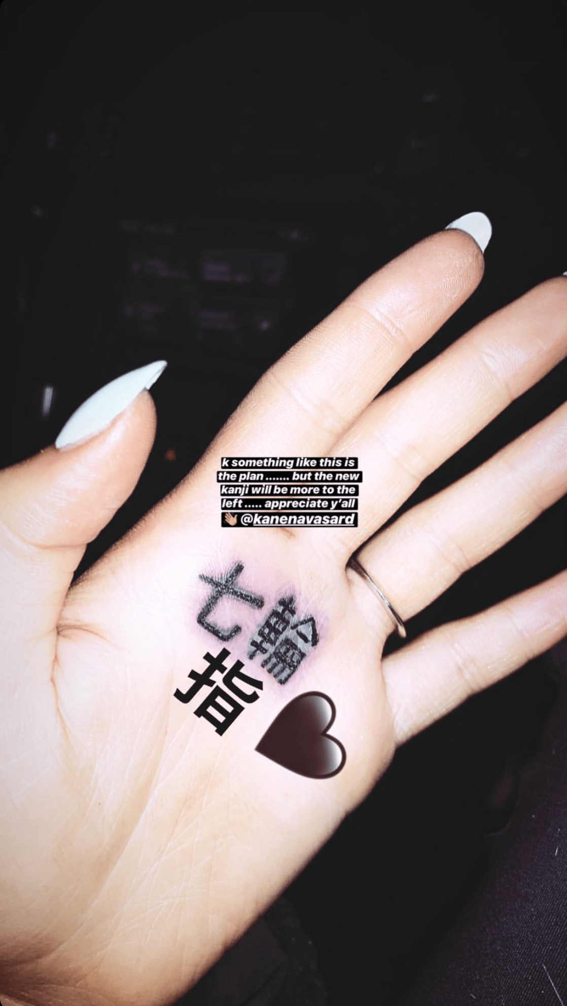 Ariana Grande trying to fix her hand tattoo