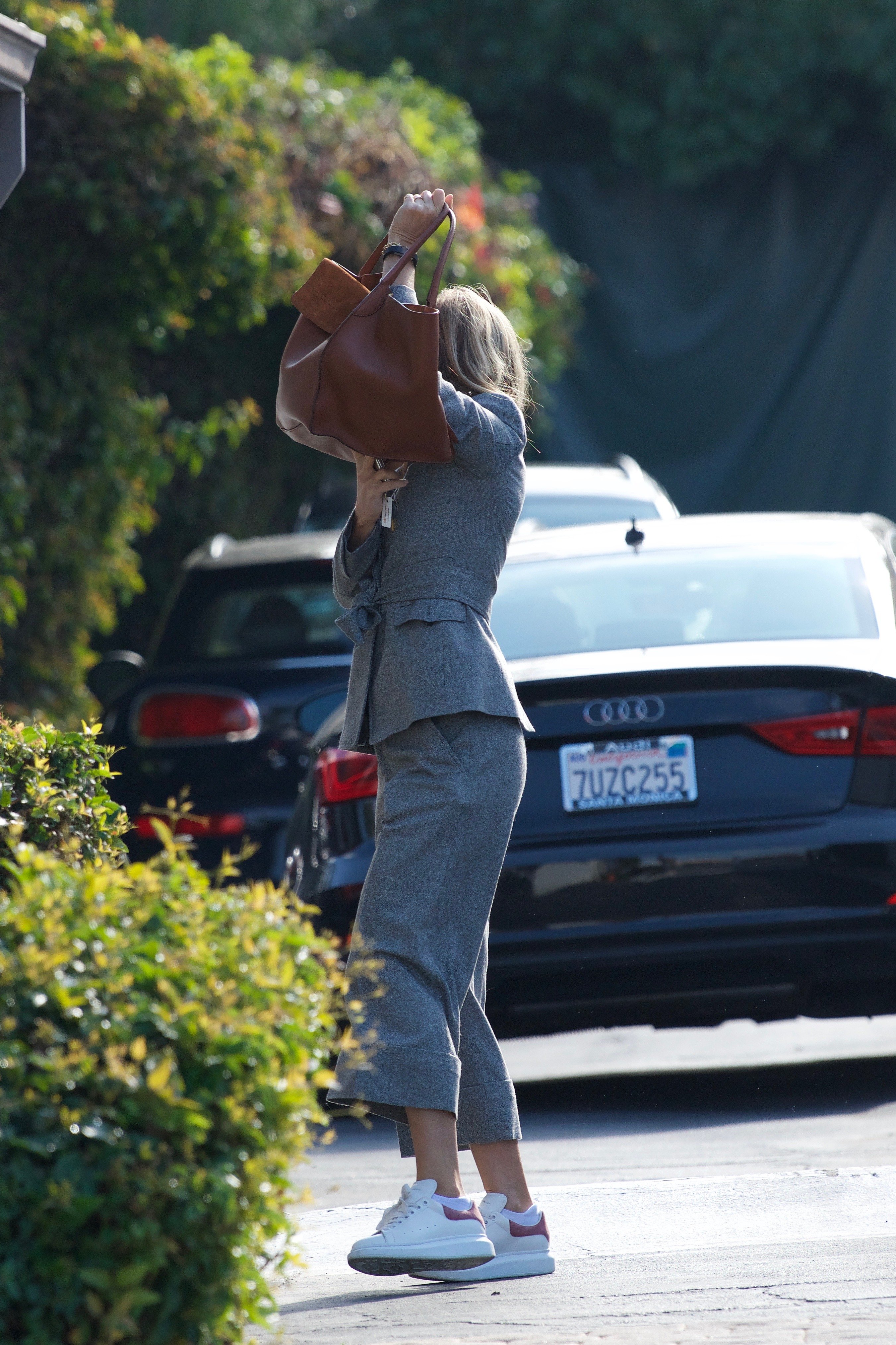 Gwyneth Paltrow trying to hide her face with her bag