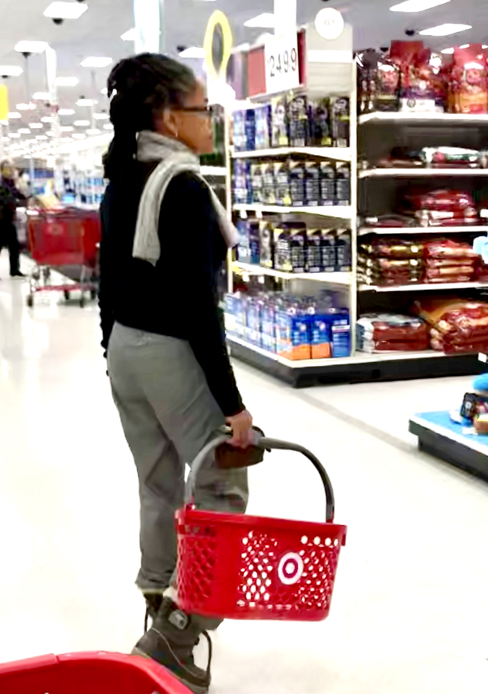 Meghan Markle's mom Doria Ragland shopping at target wearing jeans, a blue sweater, and white scarf