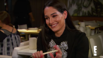 Nikki Bella smiling while eating sushi
