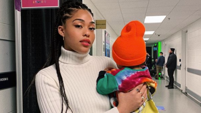 Jordyn Woods holding Stormi Webster at a Travis Scott concert