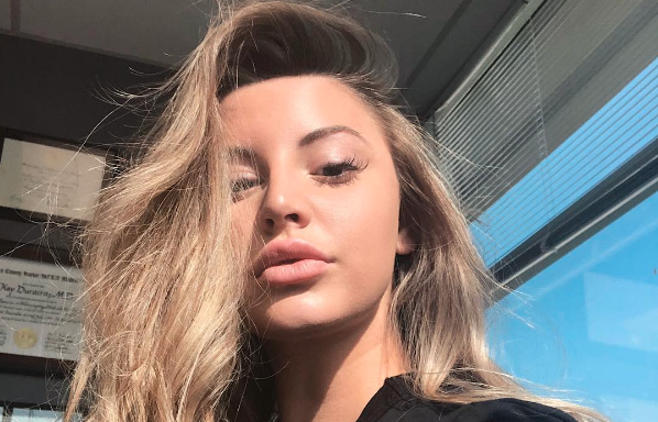Model Ashley Alexiss posing for a selfie in the sunshine