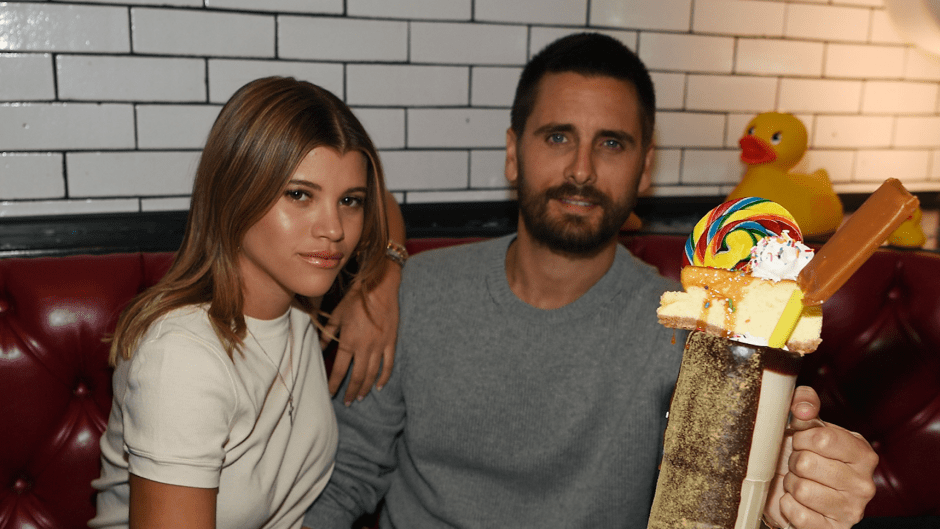Sofia Richie and Scott Disick posing together with a milkshake at Sugar Factory