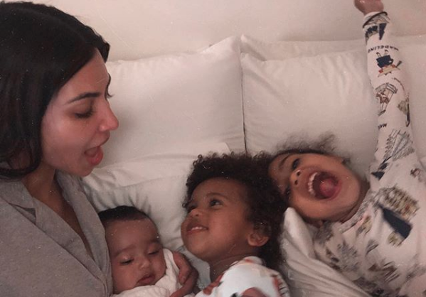 Kim Kardashian, Chicago, Saint, and North West cuddling in bed