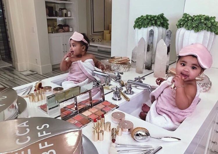 Khloe Kardashian's daughter True Thompson playing with makeup in the sink.