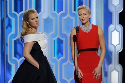 Presenters Amy Schumer and Jennifer Lawrence speak onstage during the 73rd Annual Golden Globe Awards at The Beverly Hilton Hotel on January 10, 2016