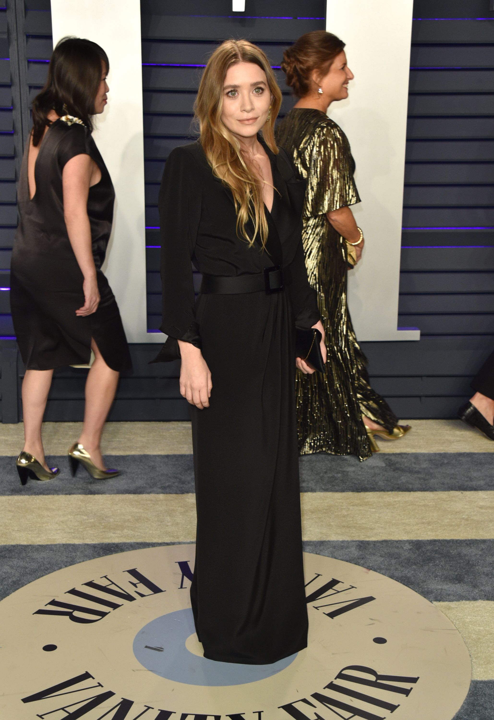 Ashley Olsen posing in a black dress with her hair down