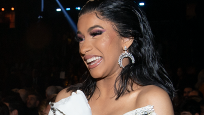 Cardi B smiling in a white dress at the 2019 Grammy Awards