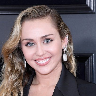 Miley Cyrus wearing a black pantsuit at the Grammys