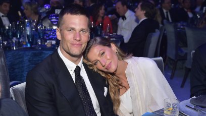 Gisele Bundchen leaning into husband Tom Brady