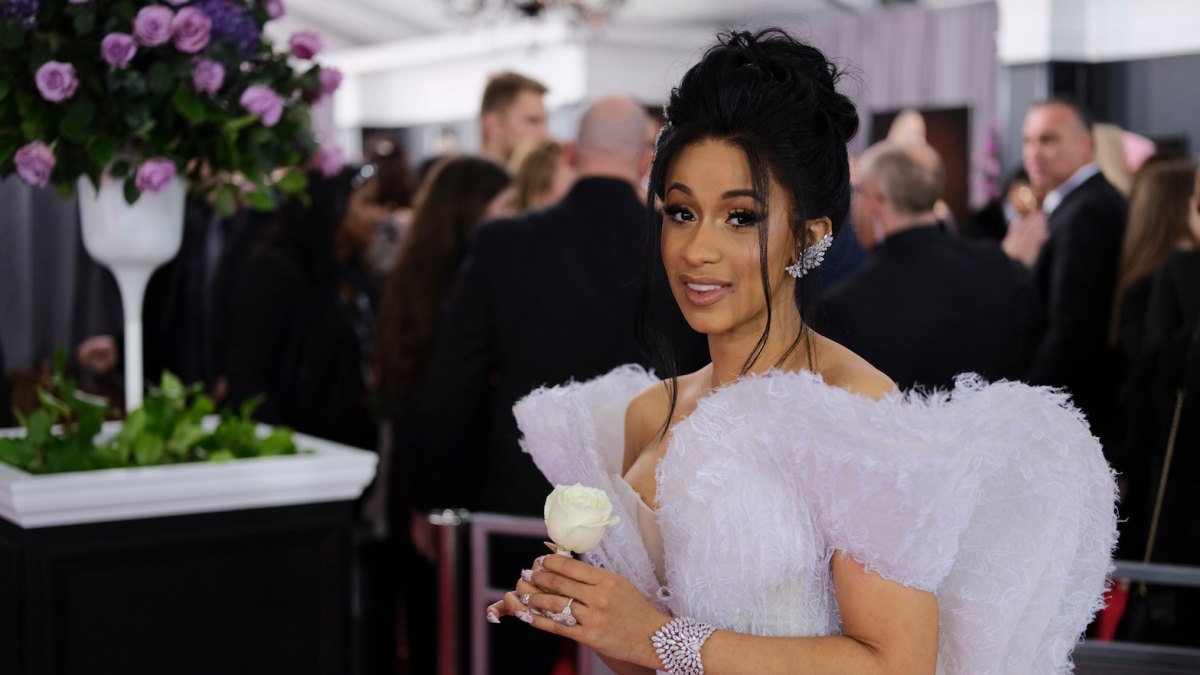 Cardi B wears a purple dress at the Grammy Awards