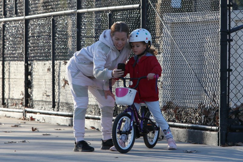 Kendra Wilkinson and Hank Baskett reunite for co-parenting their kids at the park and watch Alijah learn how to ride a bicycle.