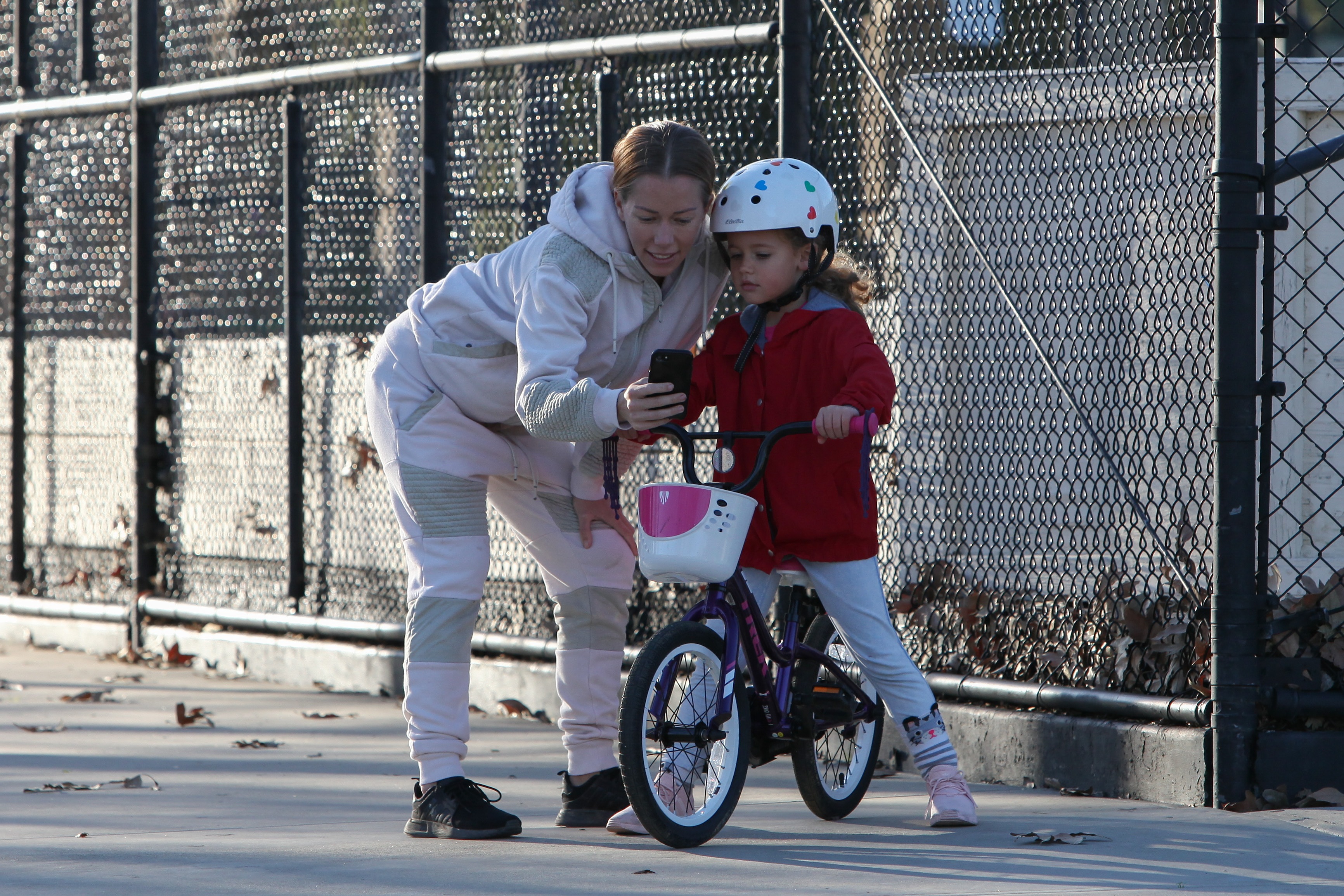 Kendra Wilkinson and Hank Baskett reunite for co-parenting their kids at the park and watch Alijah learn how to ride a bicycle.