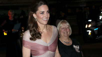 Kate Middleton smiling in a pink gown while out in London